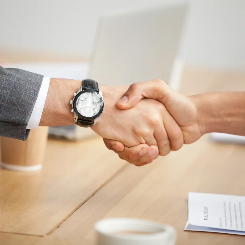 closeup-view-handshake-two-businessmen-suits-shaking-hands_11zon