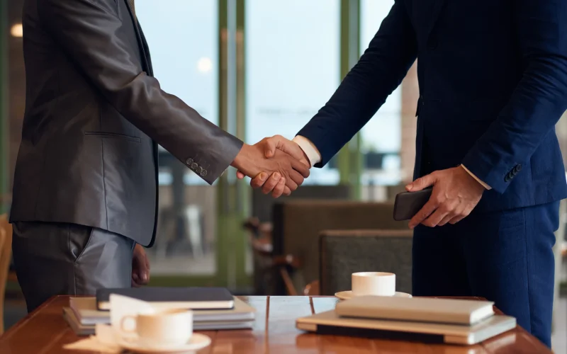 mid-section-two-unrecognizable-businessmen-shaking-hands-finalize-deal_4_11zon